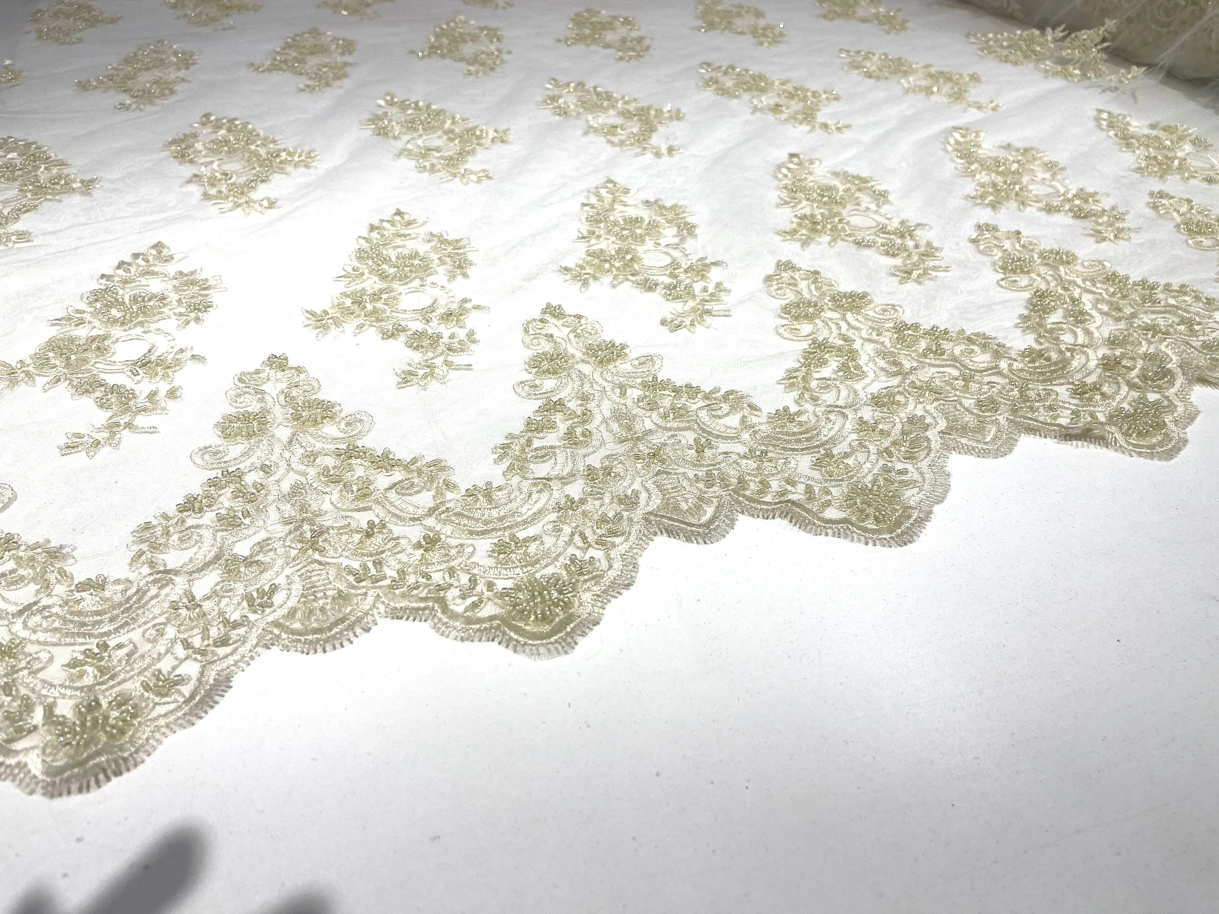 Ivory elegant hand beaded flower design embroider on a mesh lace-prom-sold by the yard.